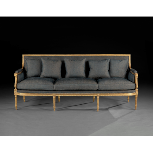 A rare suite of giltwood furniture, comprising a pair of armchairs and a long sofa